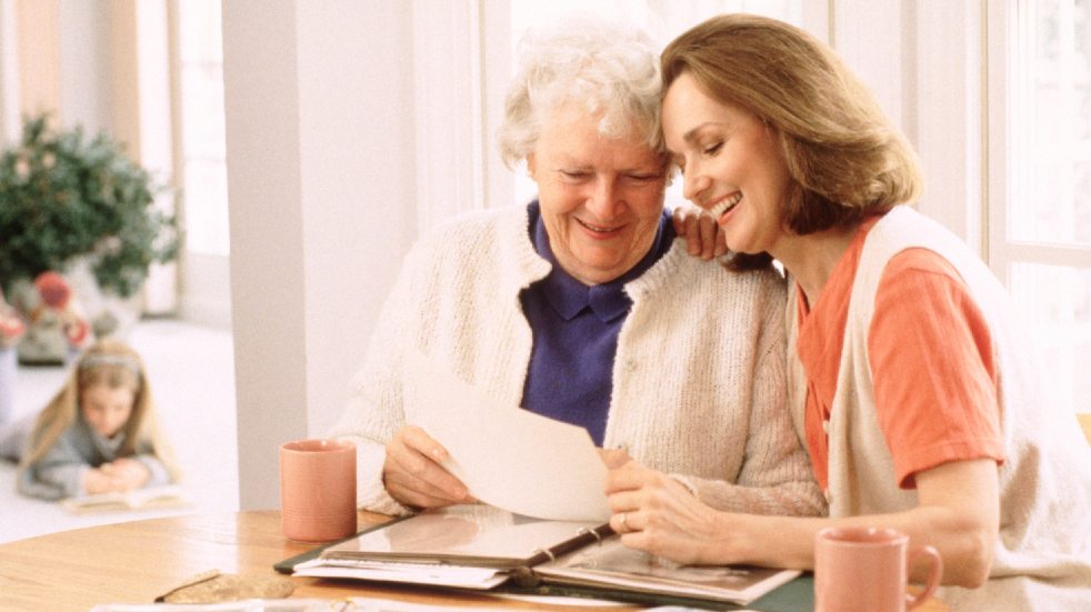 How to spend more quality time with your family woman and elderly mother looking at photos